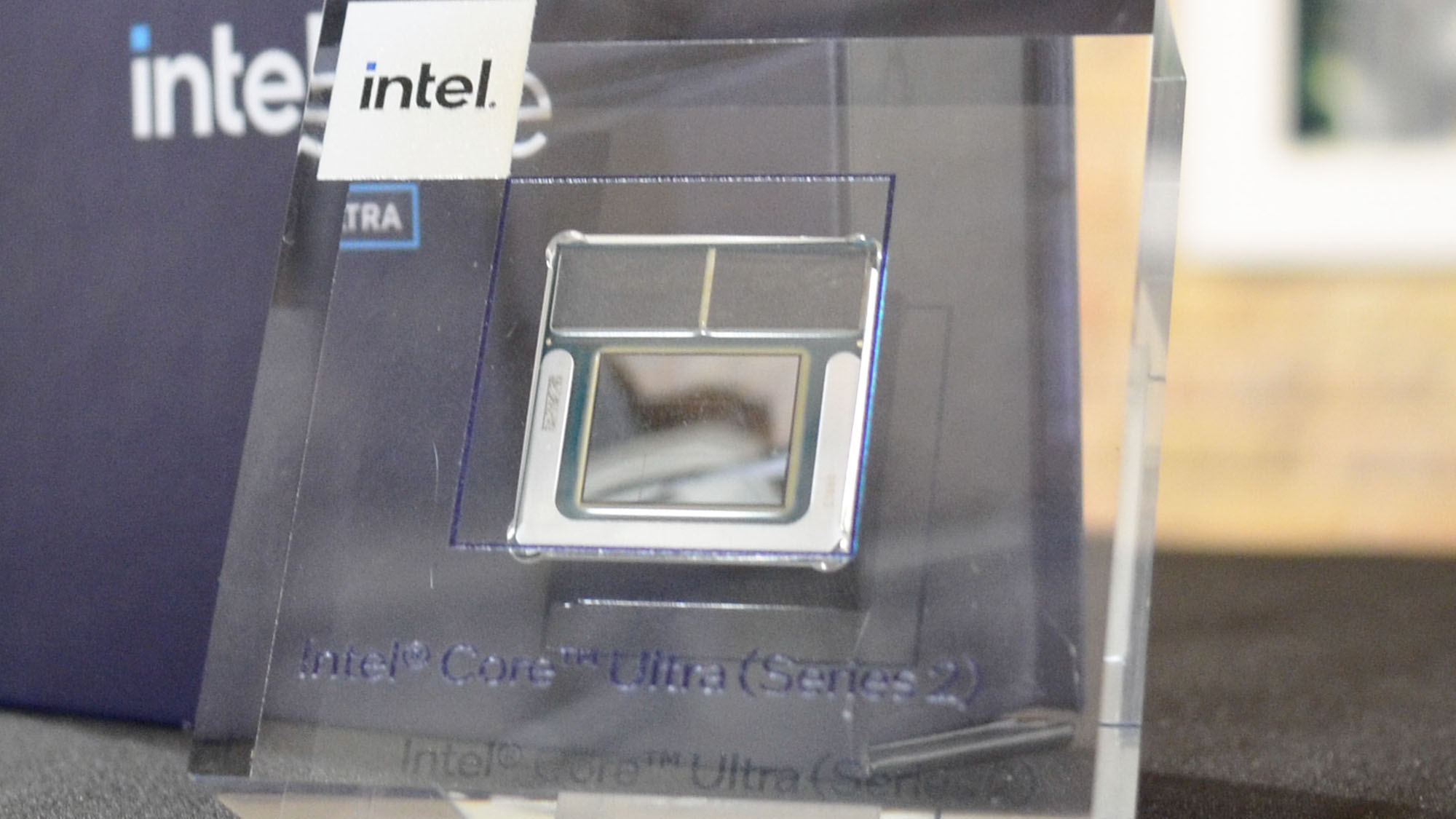 An Intel Core Ultra chip in a plastic container on a cocktail table