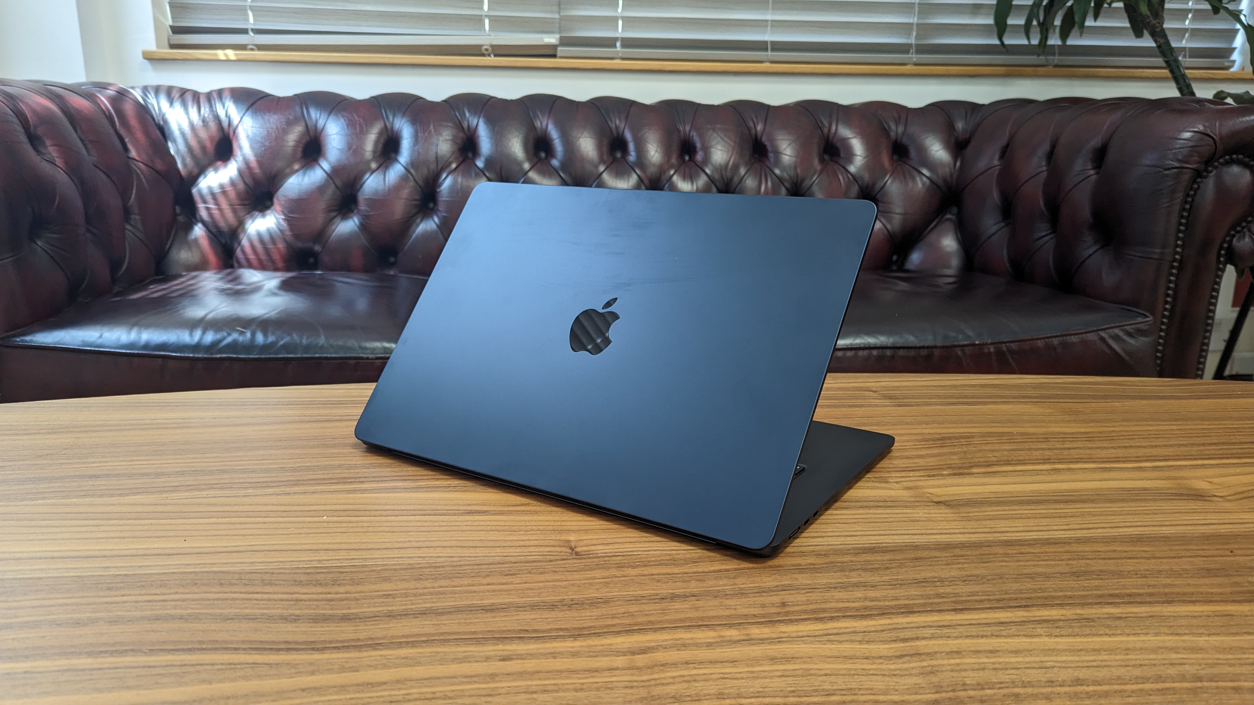 15-inch MacBook Air on wooden table at home