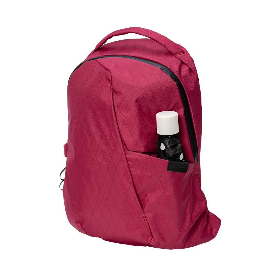 An Able Carry Thirteen Daybag in red against a pure white backdrop