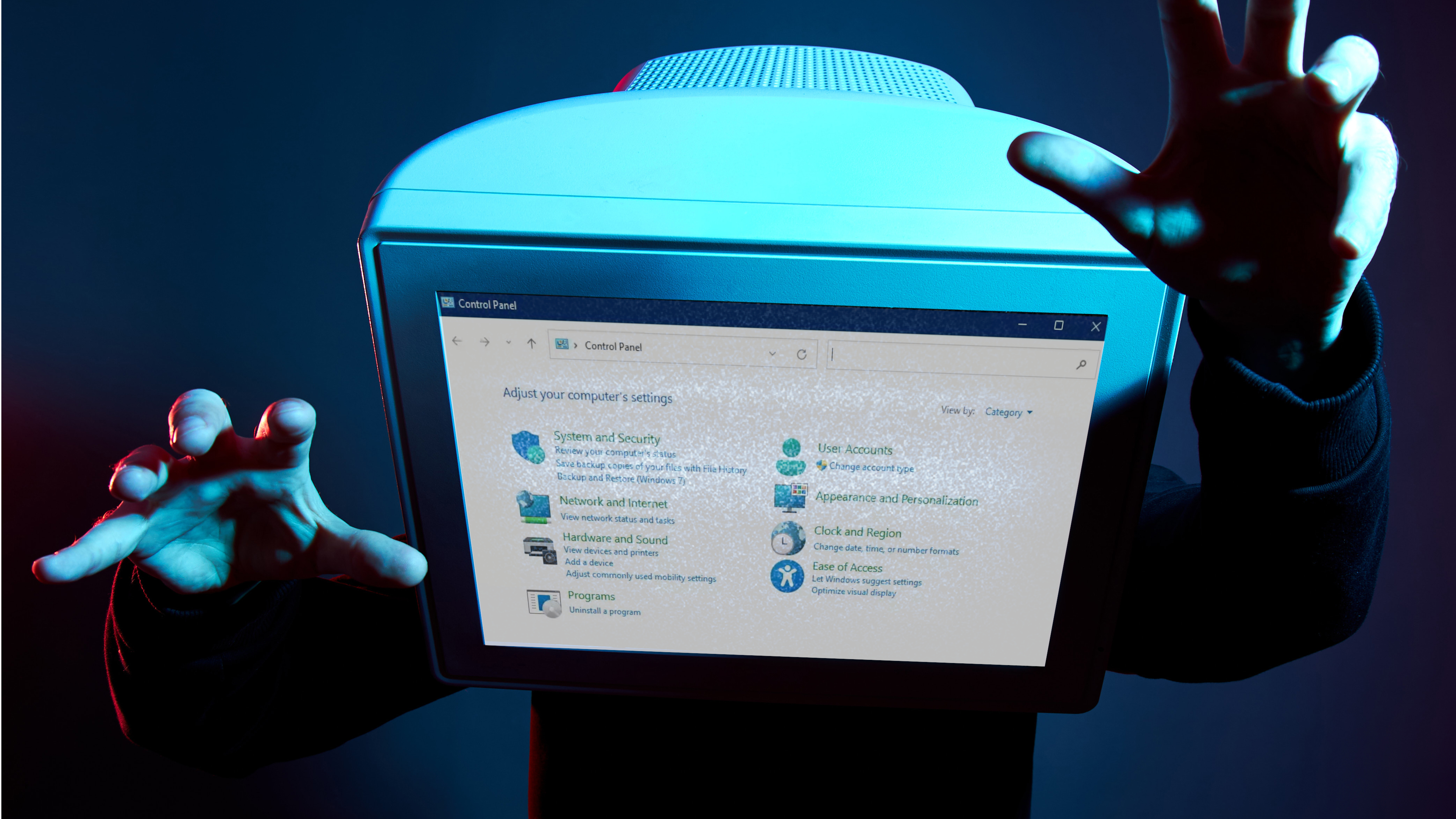 Man with a CRT monitor showing the Windows 11 control panel for a head