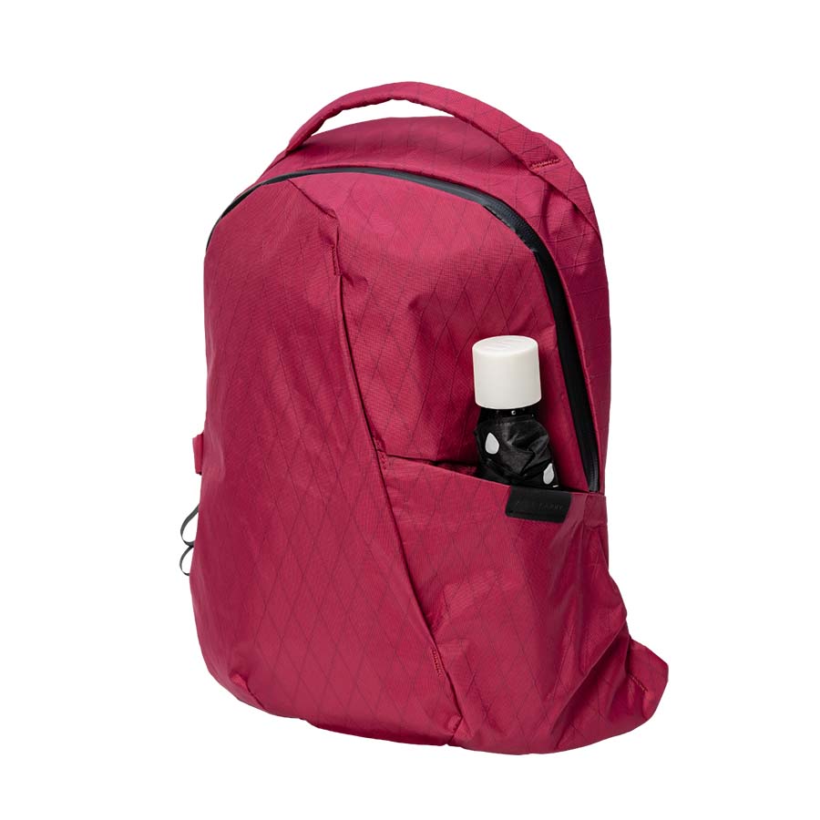 An Able Carry Thirteen Daybag in red against a pure white backdrop